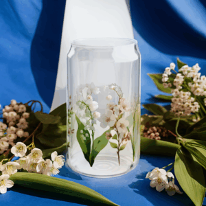 May Birth Flower Can Glass – Lily of the Valley and Hawthorn Flowers Pint Glass surrounded by lily of the valley and hawthorn flowers
